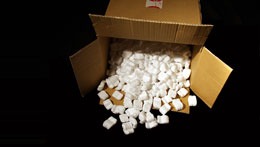 An open carton filled with packing chips